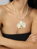 White Orchid on String of Natural Freshwater Pearls